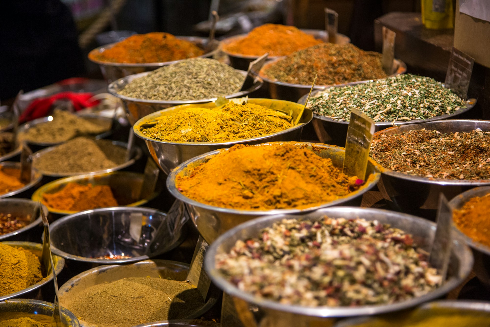 Open bowls of whole spices at a market
