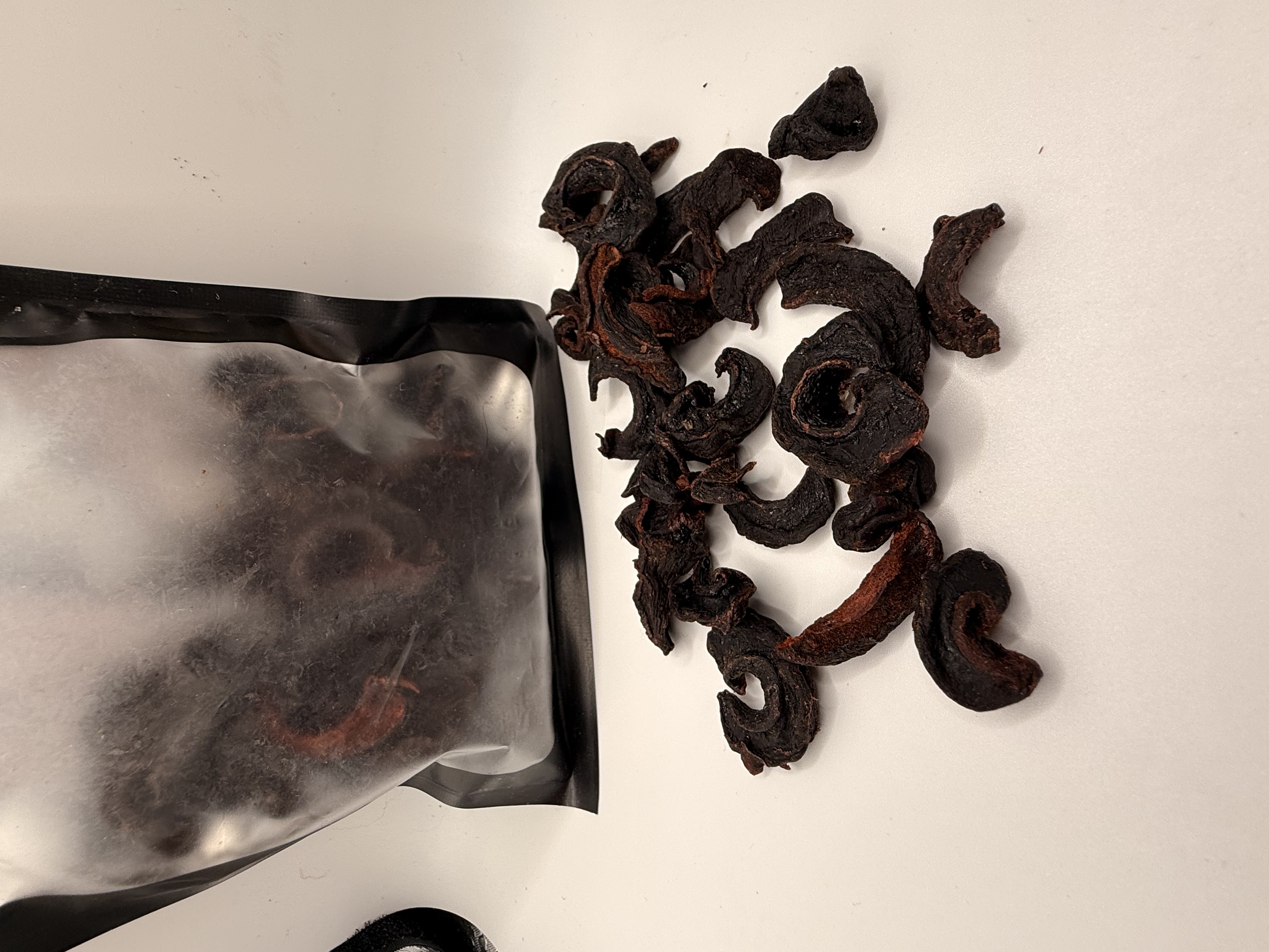 Sri Lanka Dried Goraka — sun-dried Garcinia rind pieces spilling from a black pouch
