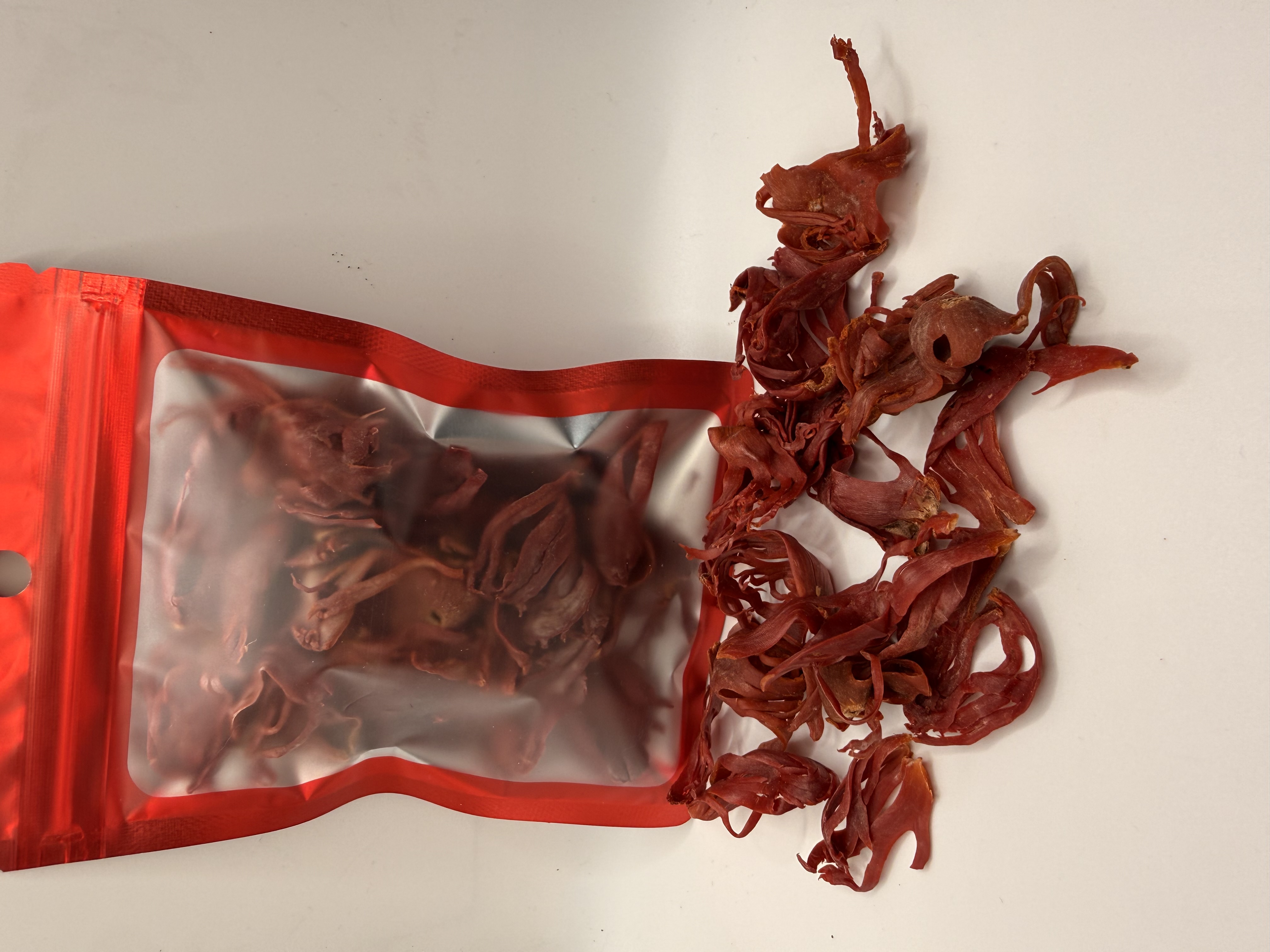 Sri Lanka Nut Mace — 2 oz red resealable pouch with product spilled beside it