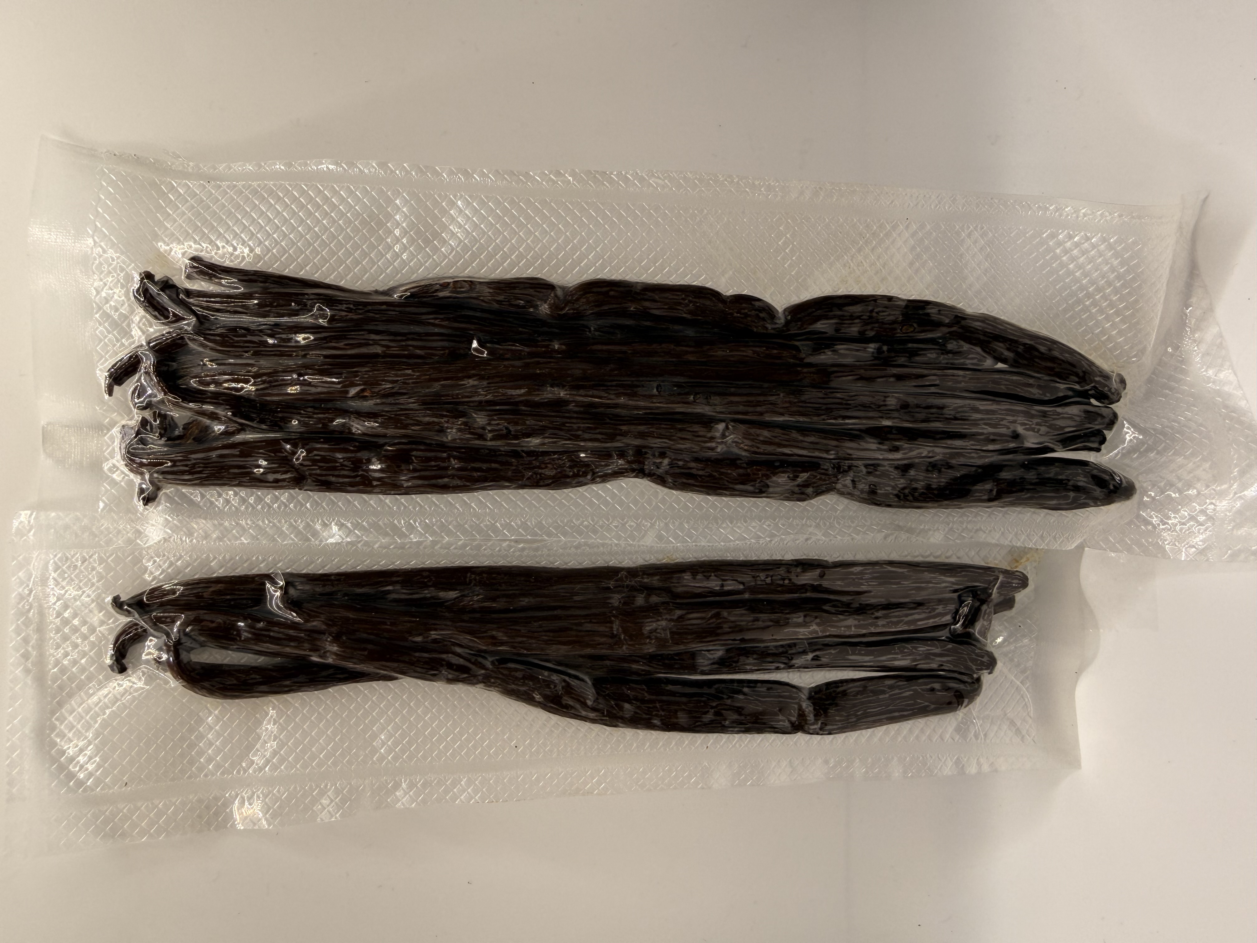 Josie's Sweet Caviar Uganda Grade A Vanilla Beans — two vacuum-sealed pouches of glossy black pods